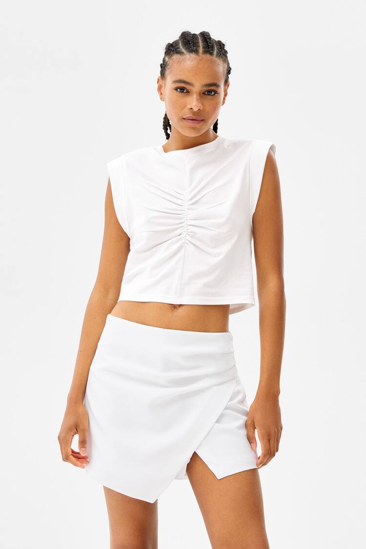 Sleeveless top with seam detail and front pleat