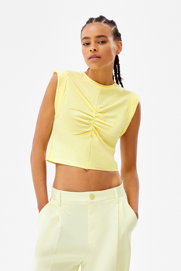 Sleeveless top with seam detail and front pleat