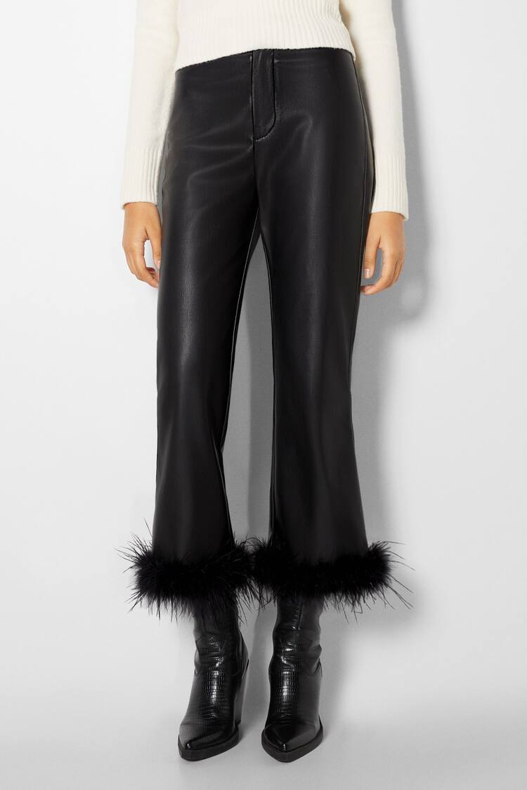 Faux leather trousers with feathers