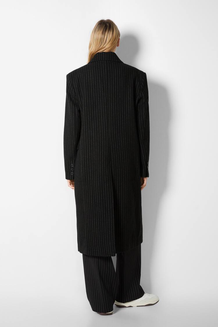 Pinstriped wool coat with a masculine cut