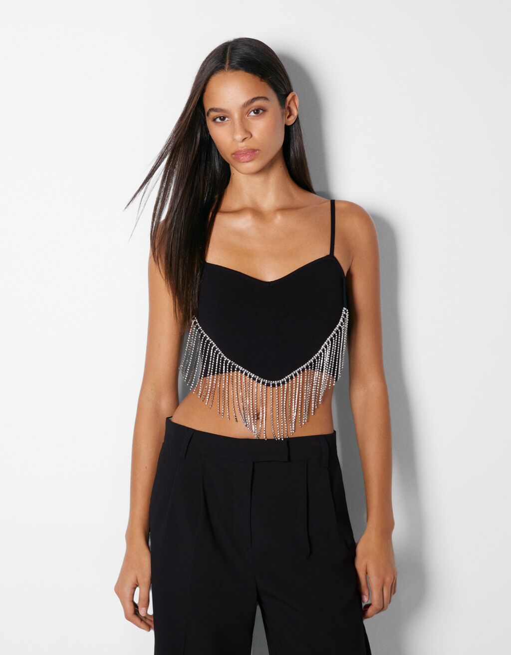 Knit top with sweetheart neckline and fringing