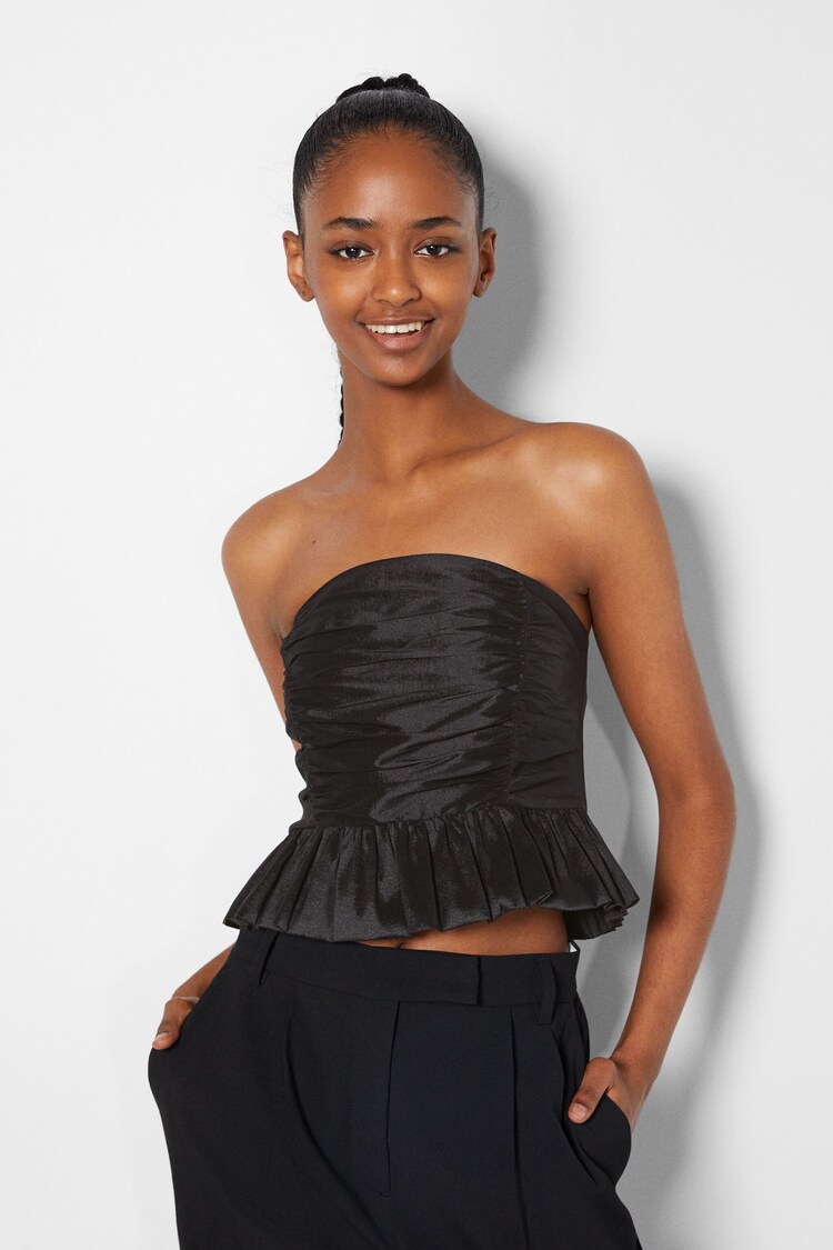 Sleeveless panelled top with peplum detail
