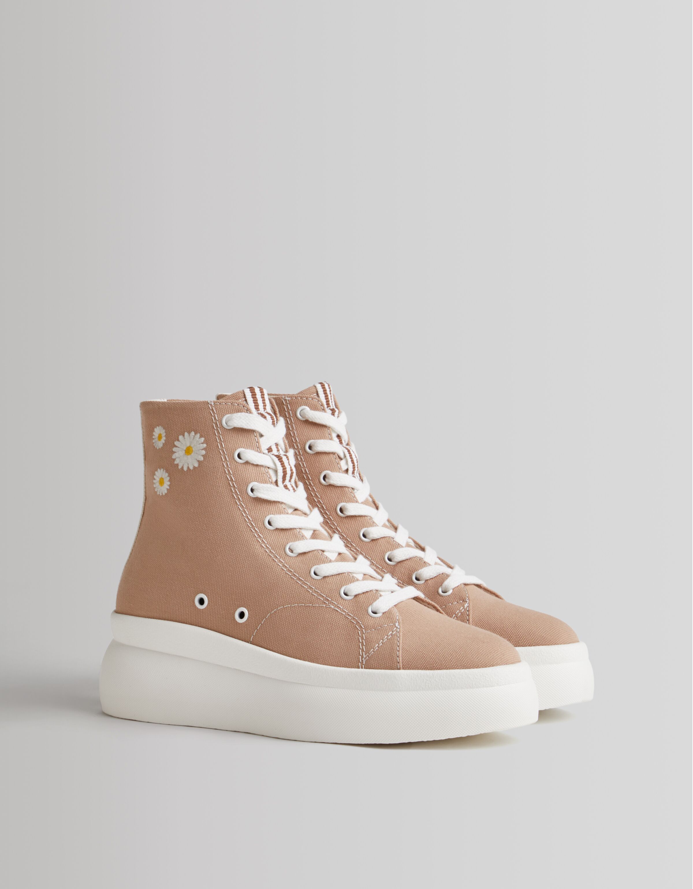 gold and white platform converse