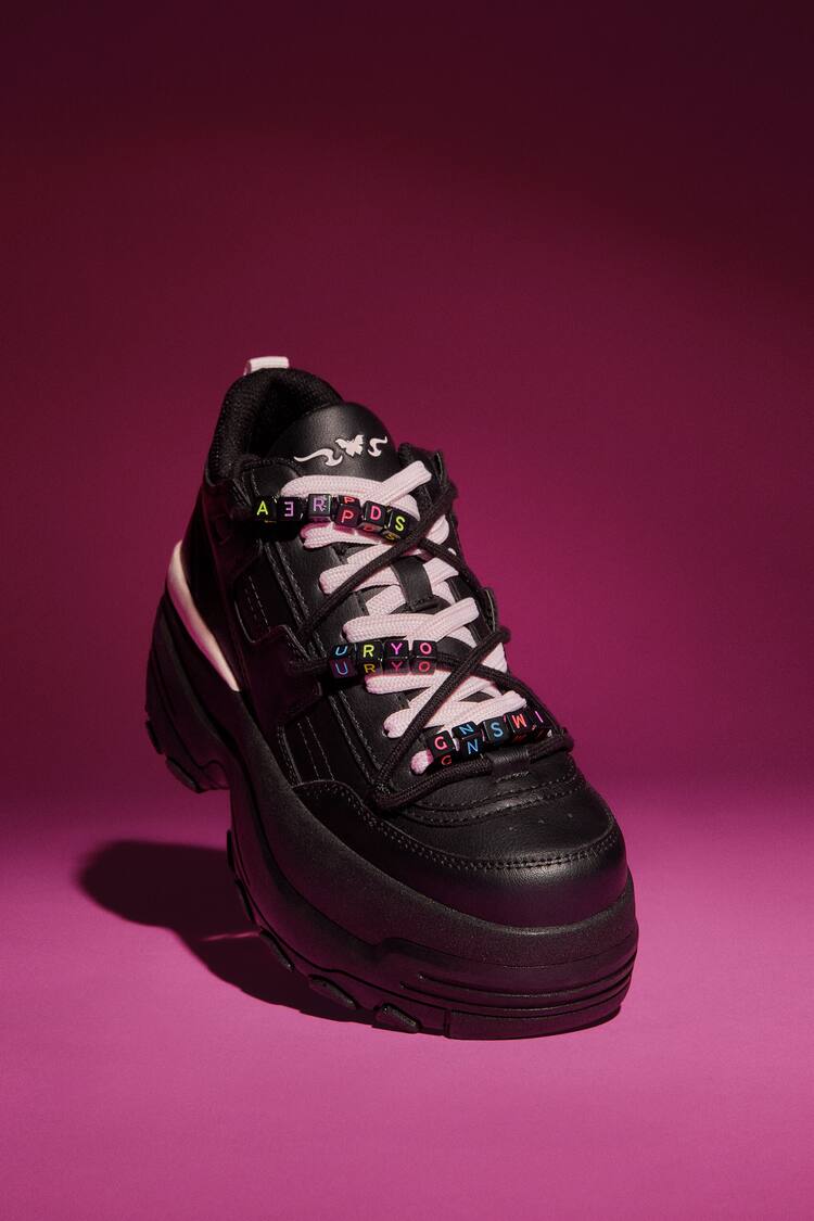 XL trainers with decorative details.