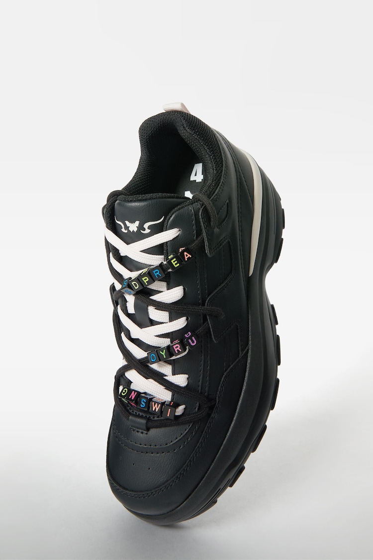 XL trainers with decorative details.