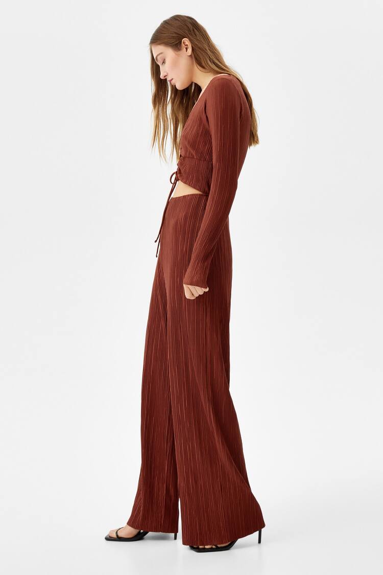 Jumpsuit featuring long sleeves and front cut-out detail