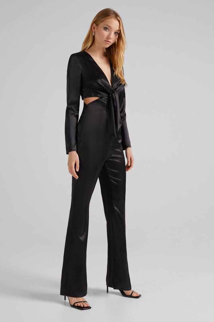 Long satin jumpsuit with long sleeves, V-neckline and cut-out knot detail