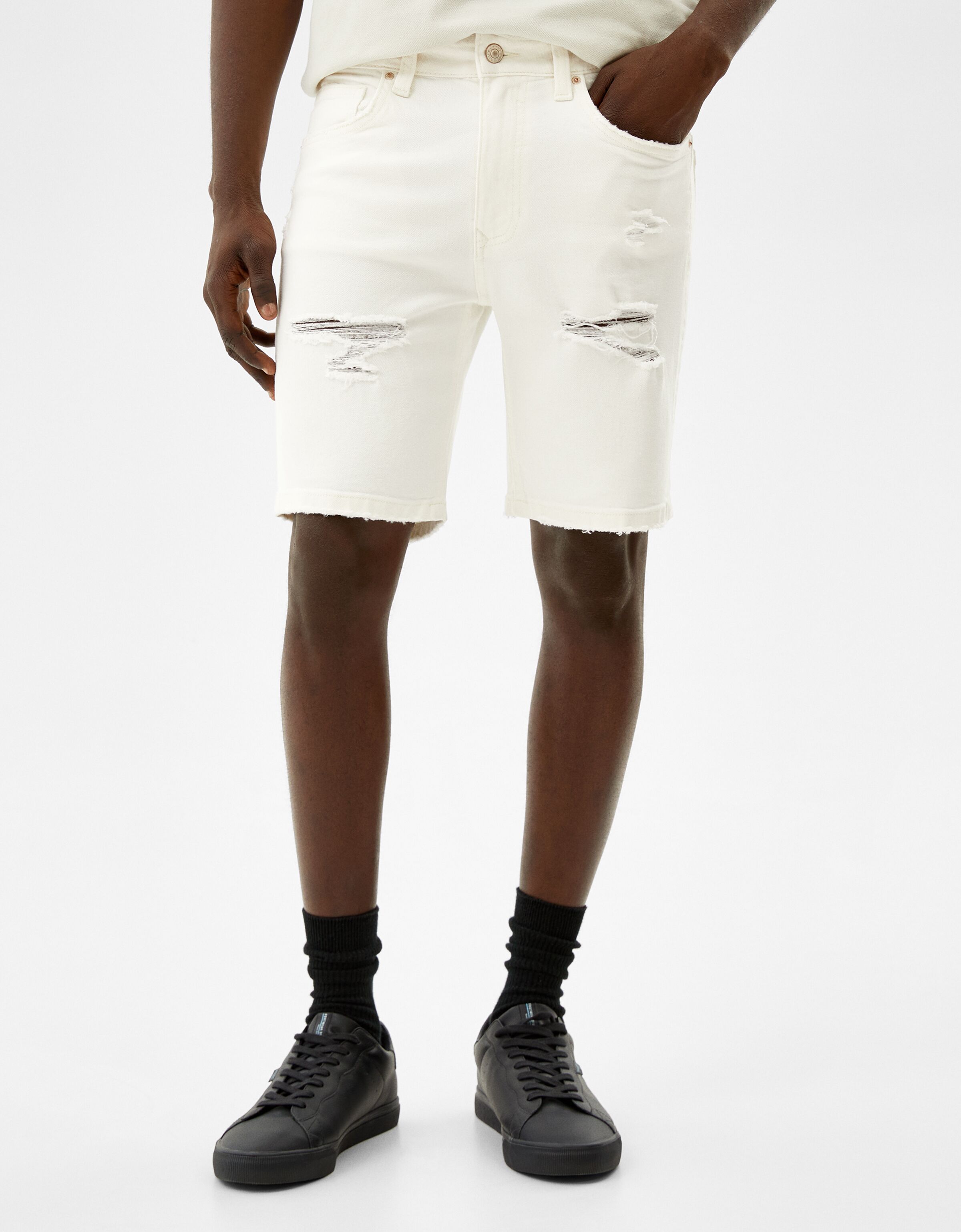 Skinny denim Bermuda shorts with rips 