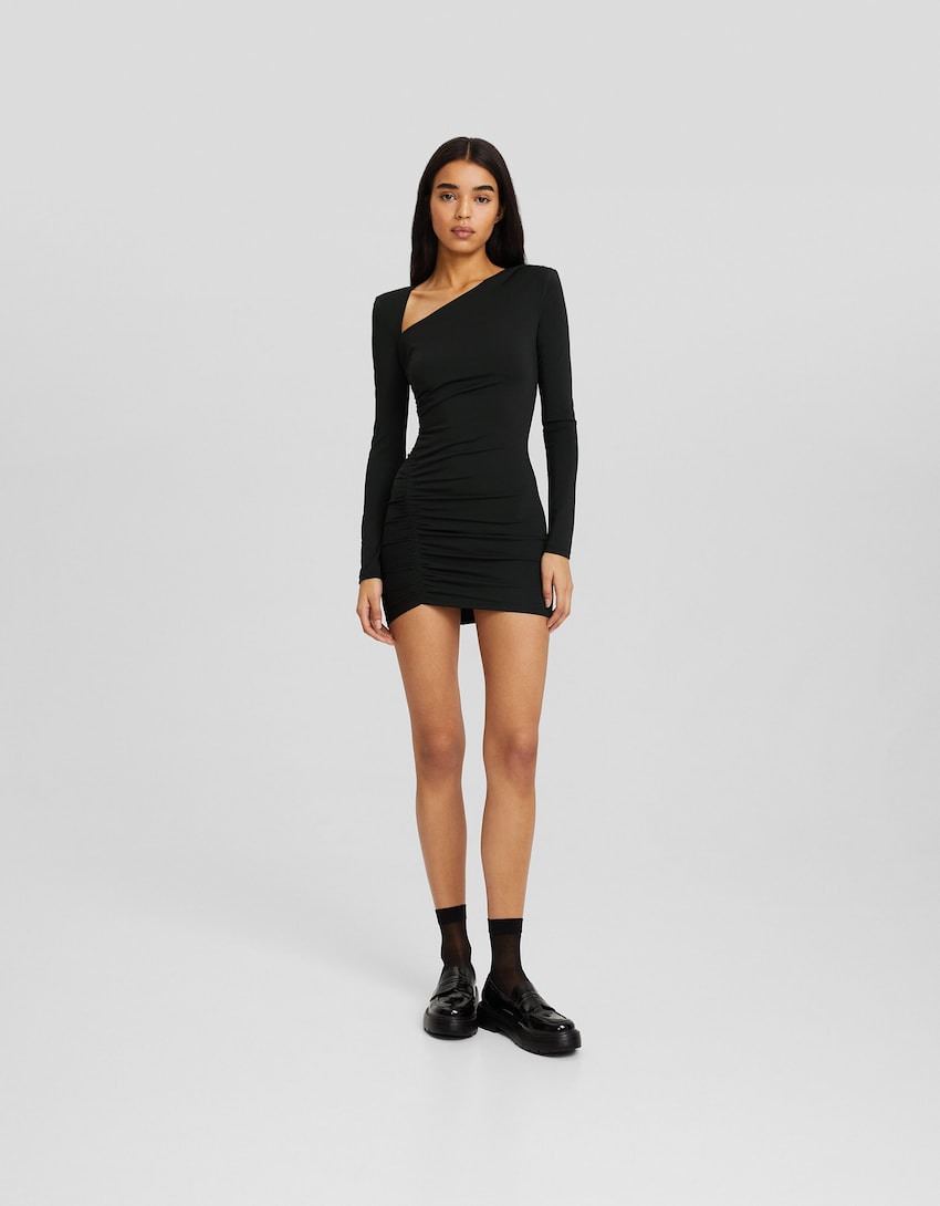Long sleeve mini dress with gathered detailing on the side and shoulder pads