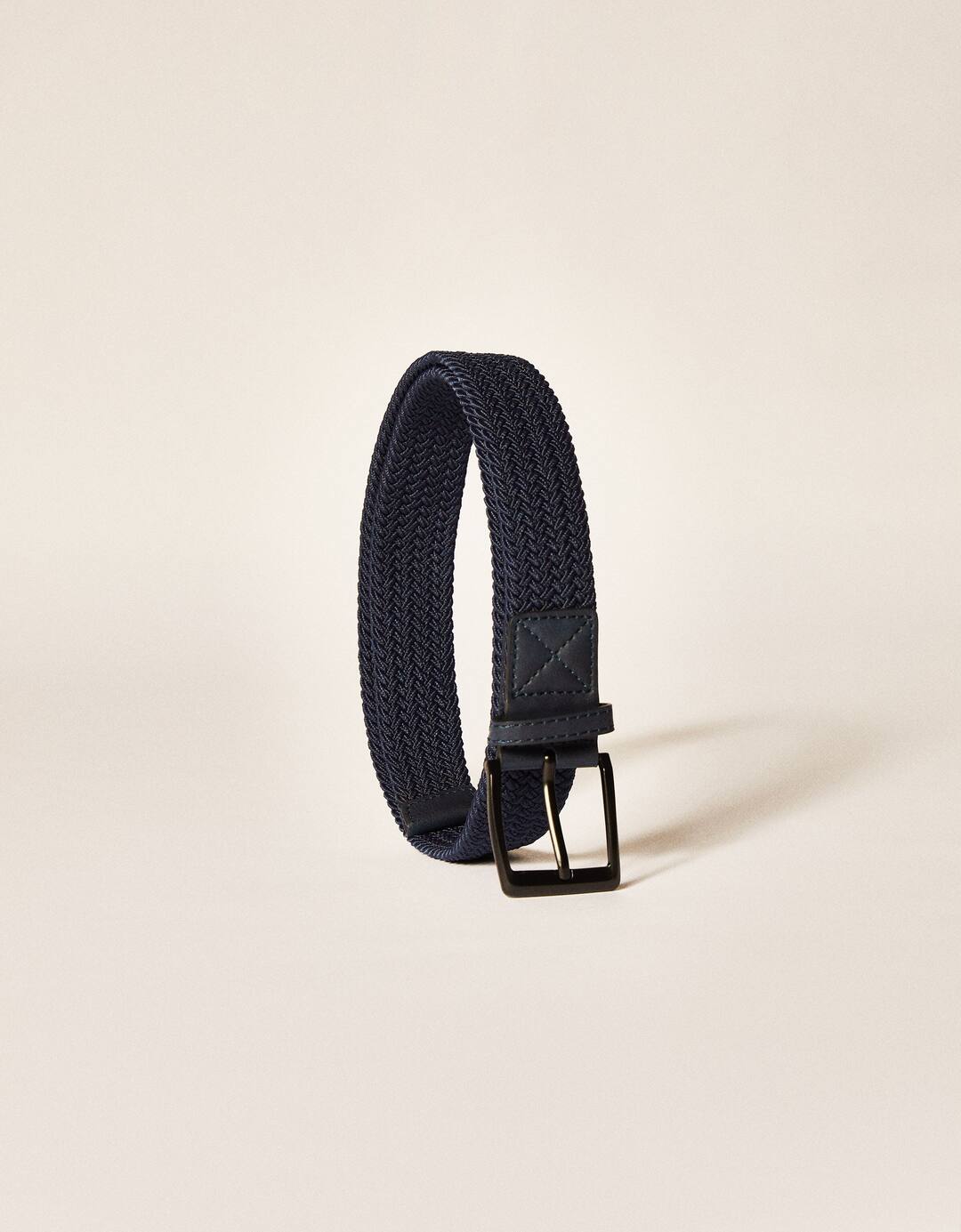 Braided belt with faux leather detail