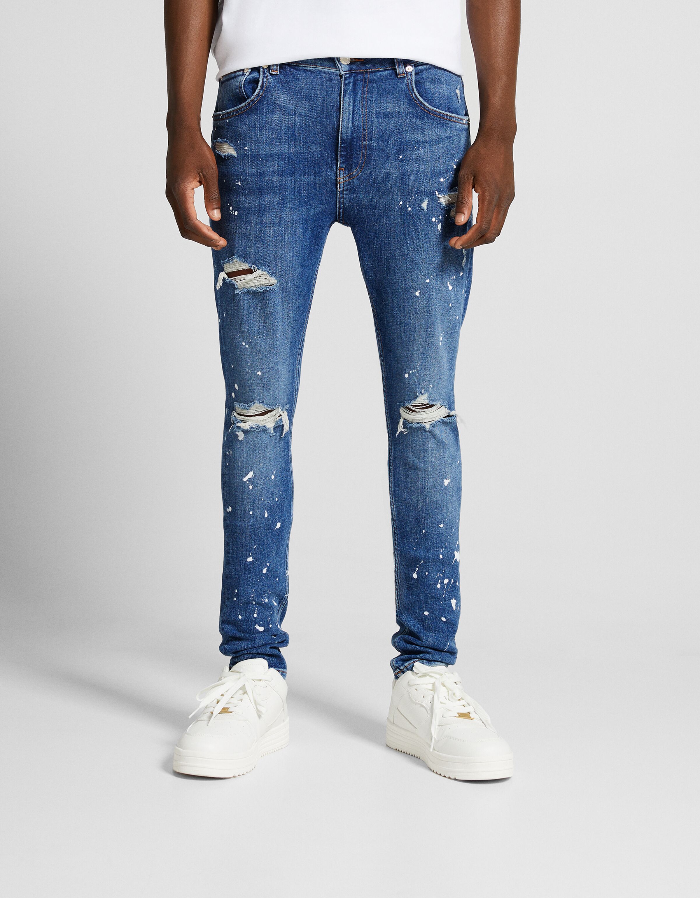 Ripped super skinny jeans with paint splatter