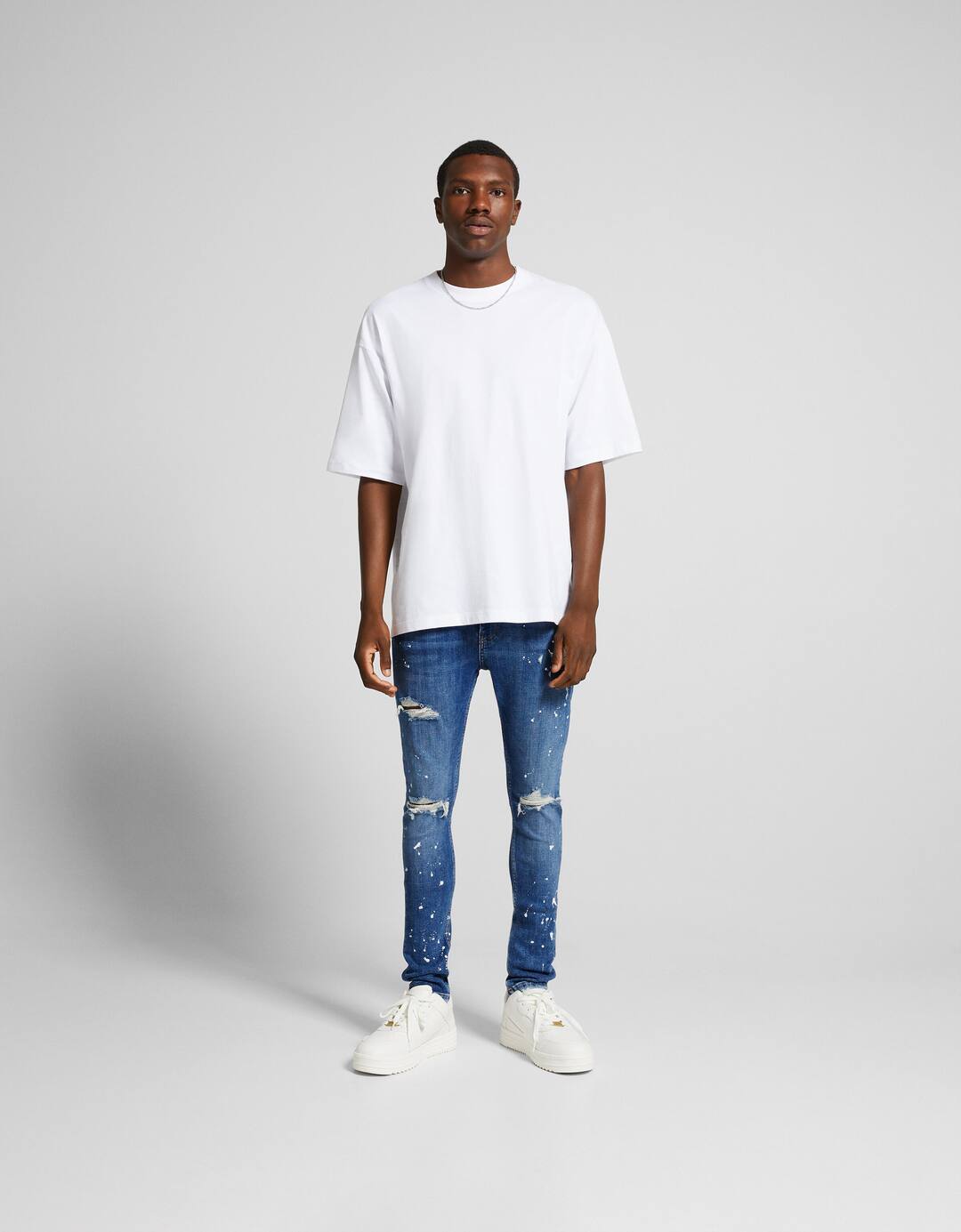Ripped super skinny jeans with paint splatter