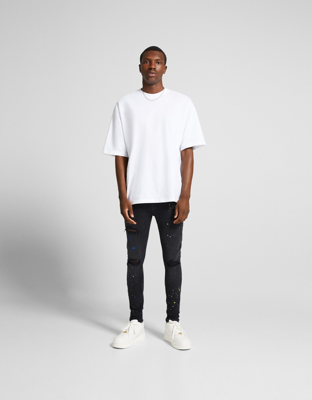 Jeans super skinny strappati effetto pittura