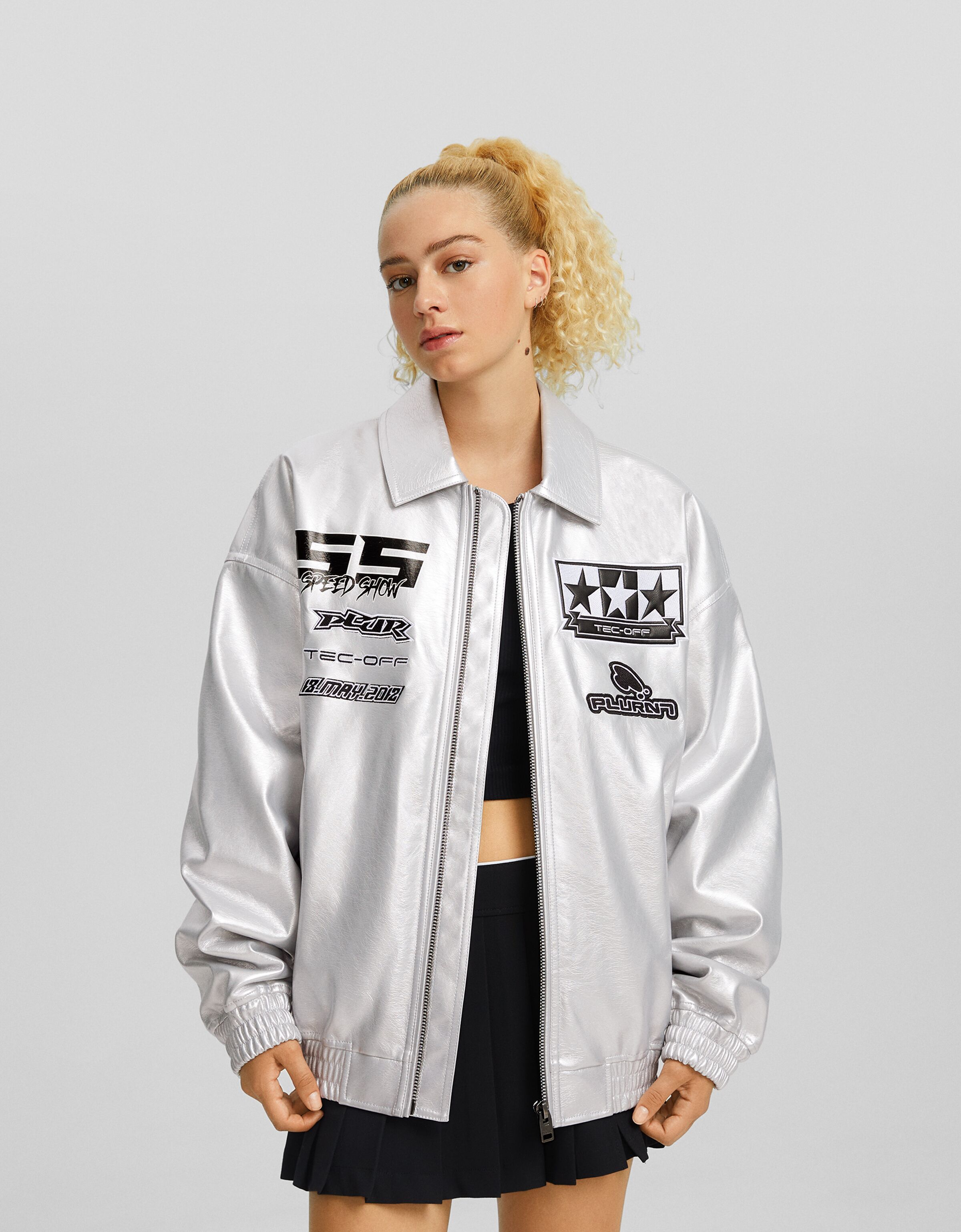 Metallic faux leather jacket with patches Men Bershka