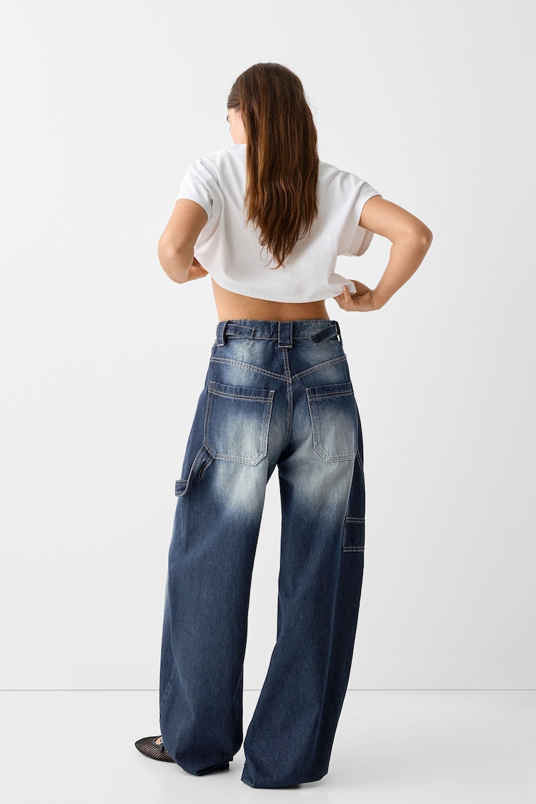 Apsmunkantys darbo drabužių stiliaus džinsai
