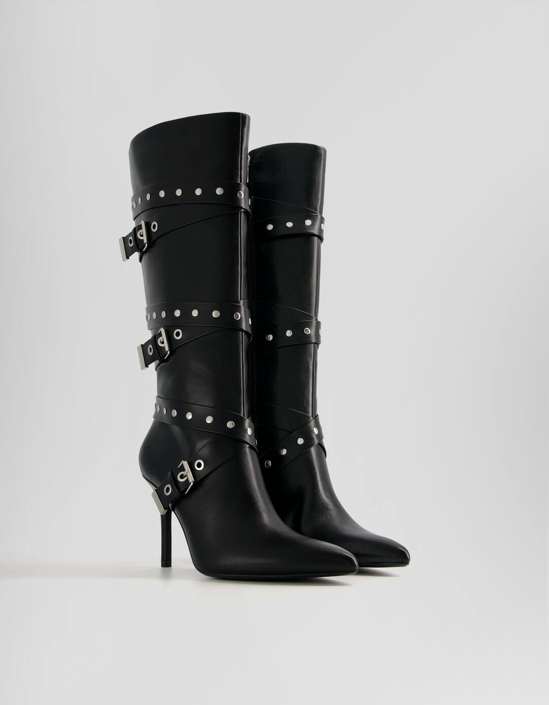 High-heel boots with studded and buckled straps
