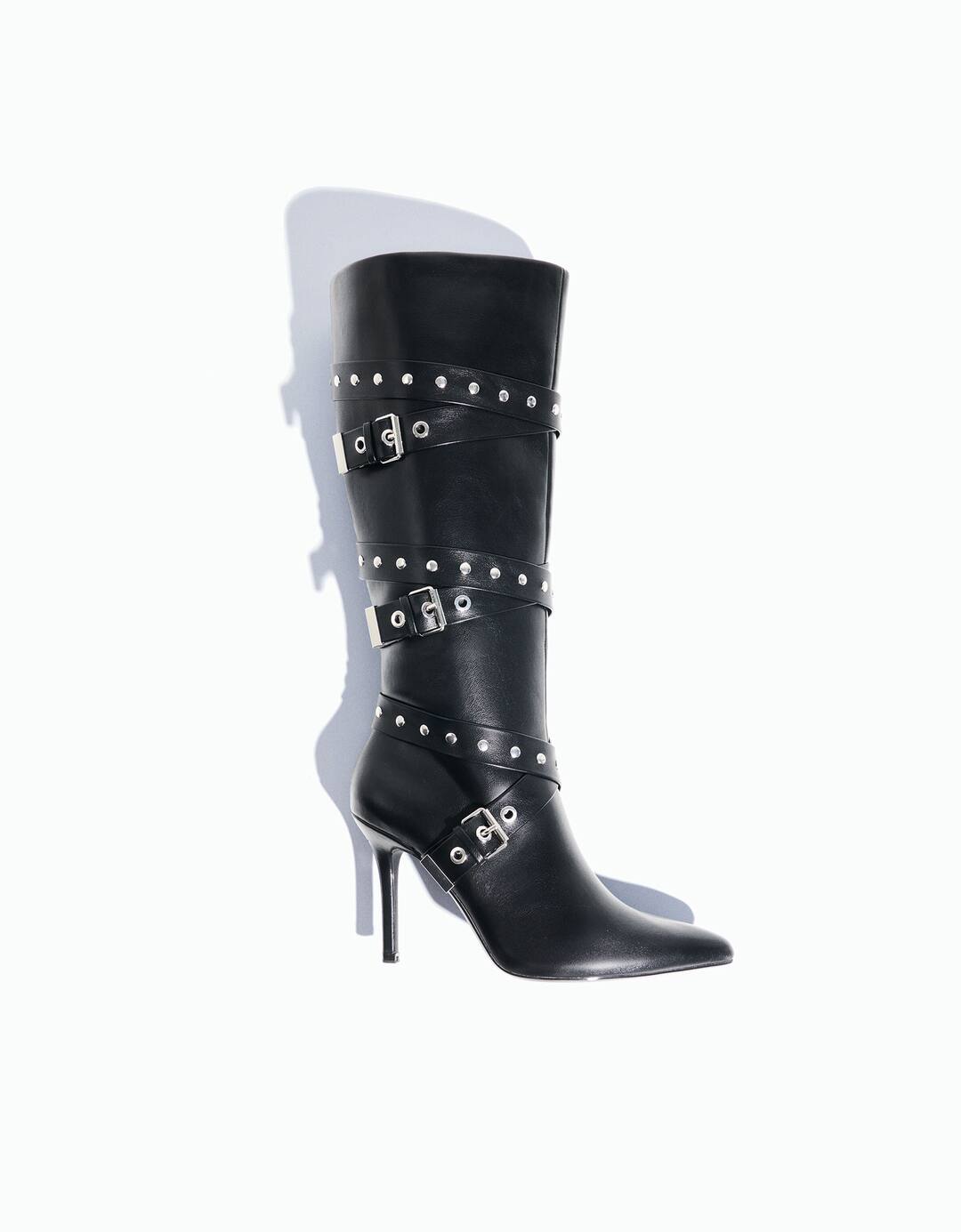 High-heel boots with studded and buckled straps