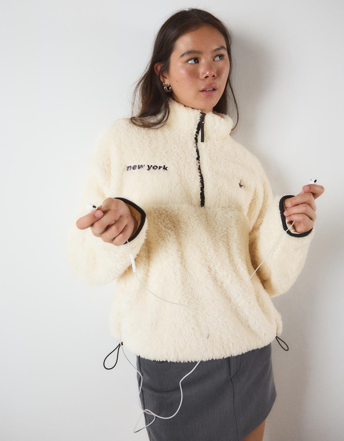 Pull zippé effet peau de mouton, base ajustable