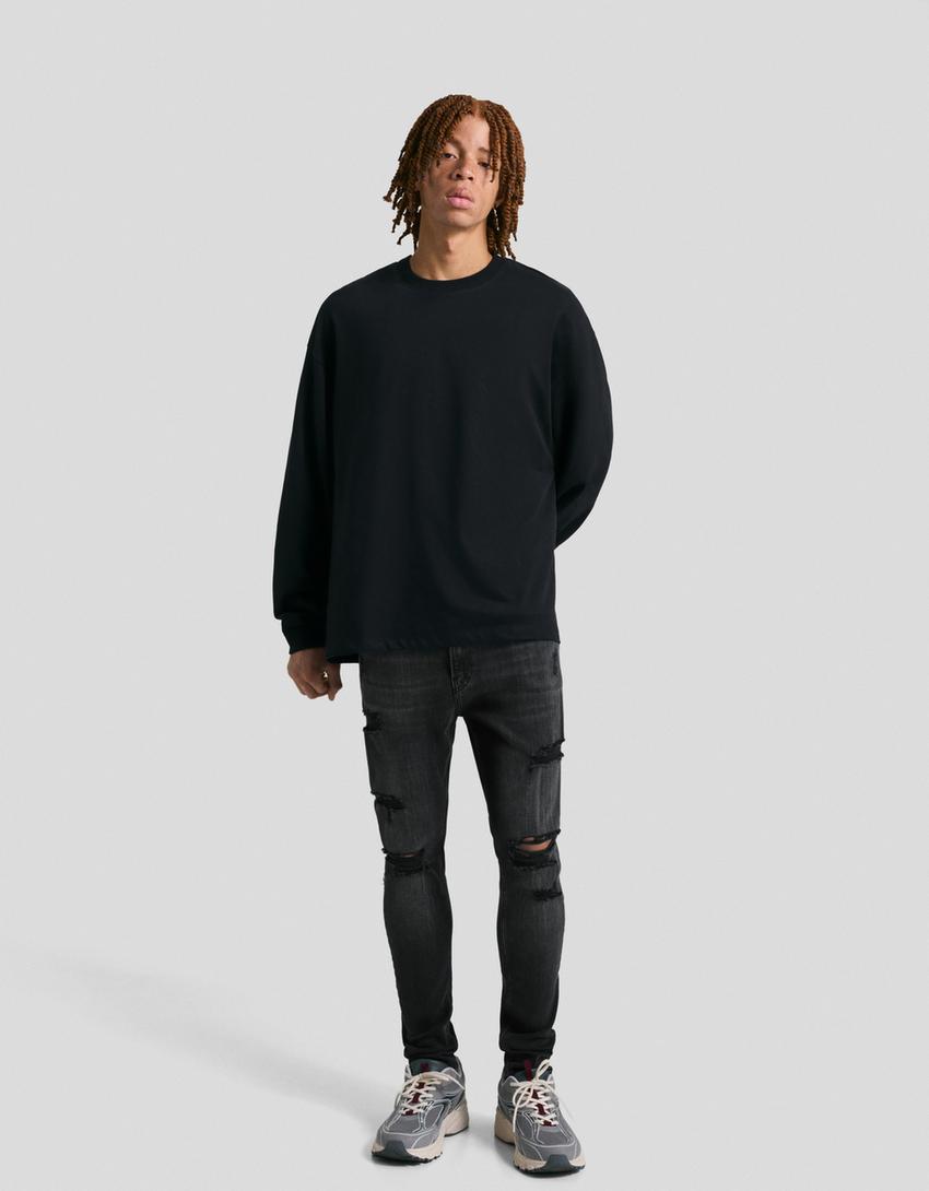Jeans super skinny strappati-Nero