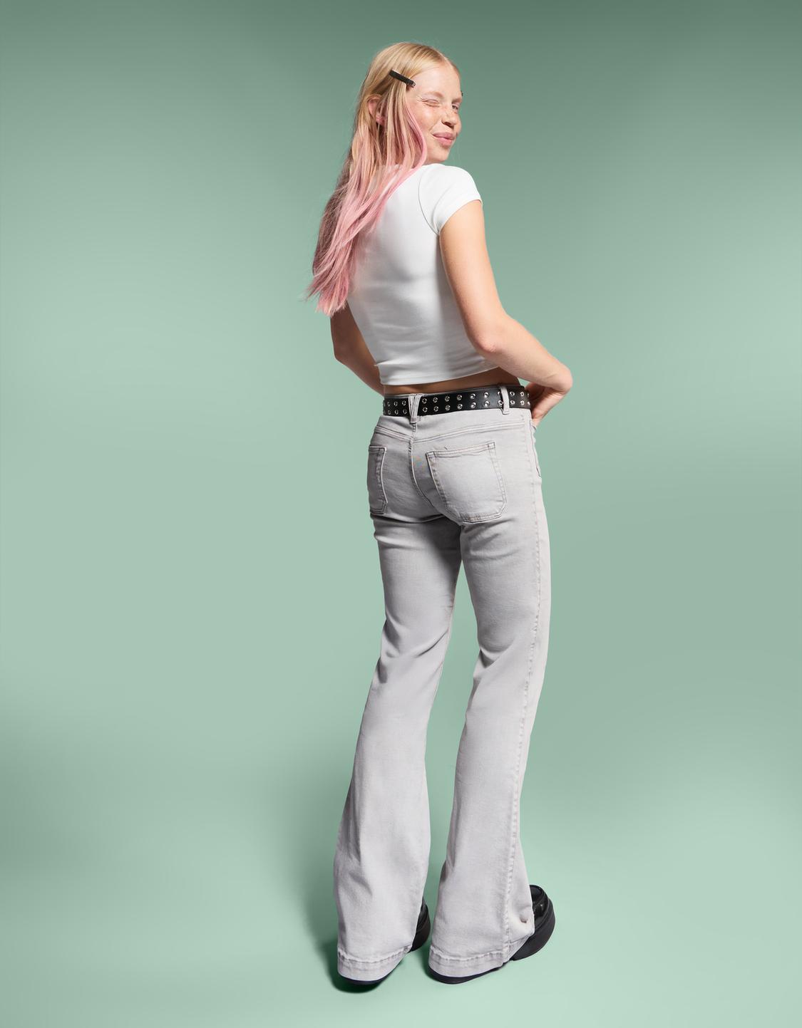 Flare trousers with flaps and pocket