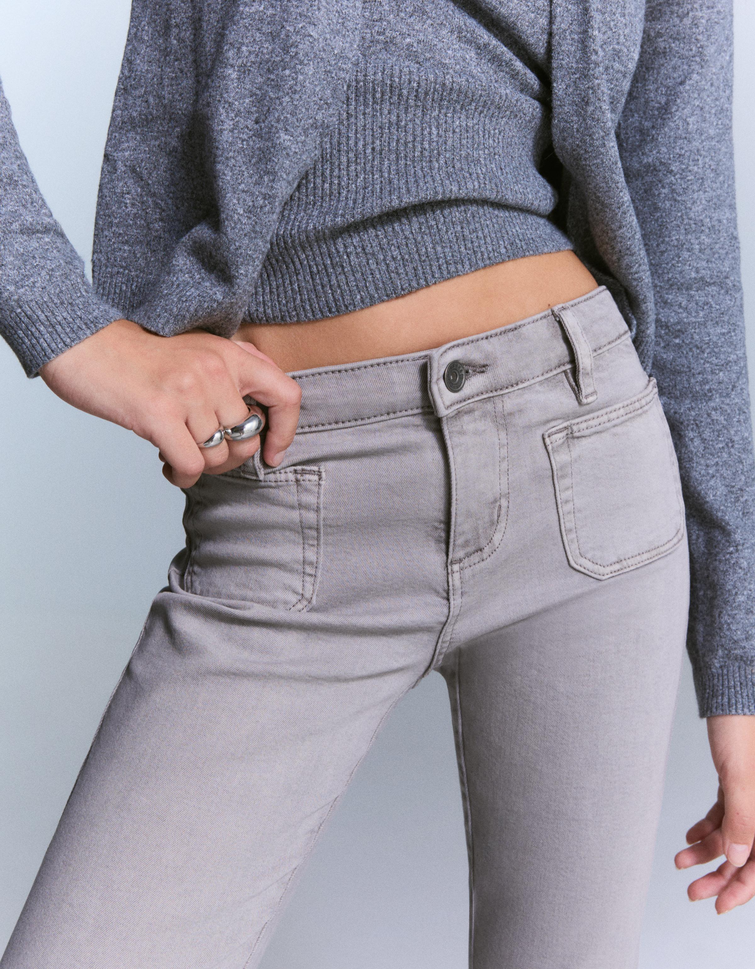 Flare trousers with flaps and pocket