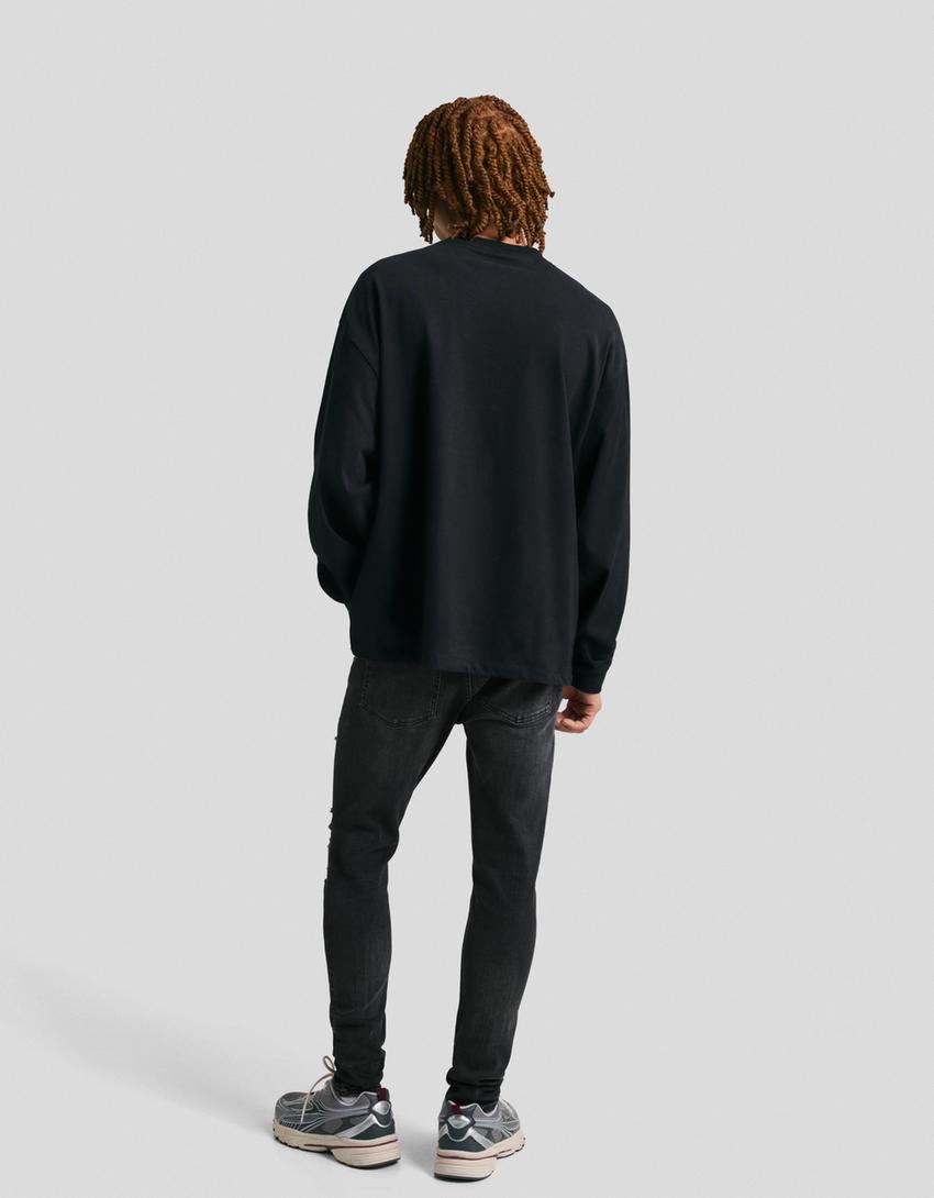 Jeans super skinny strappati-Nero