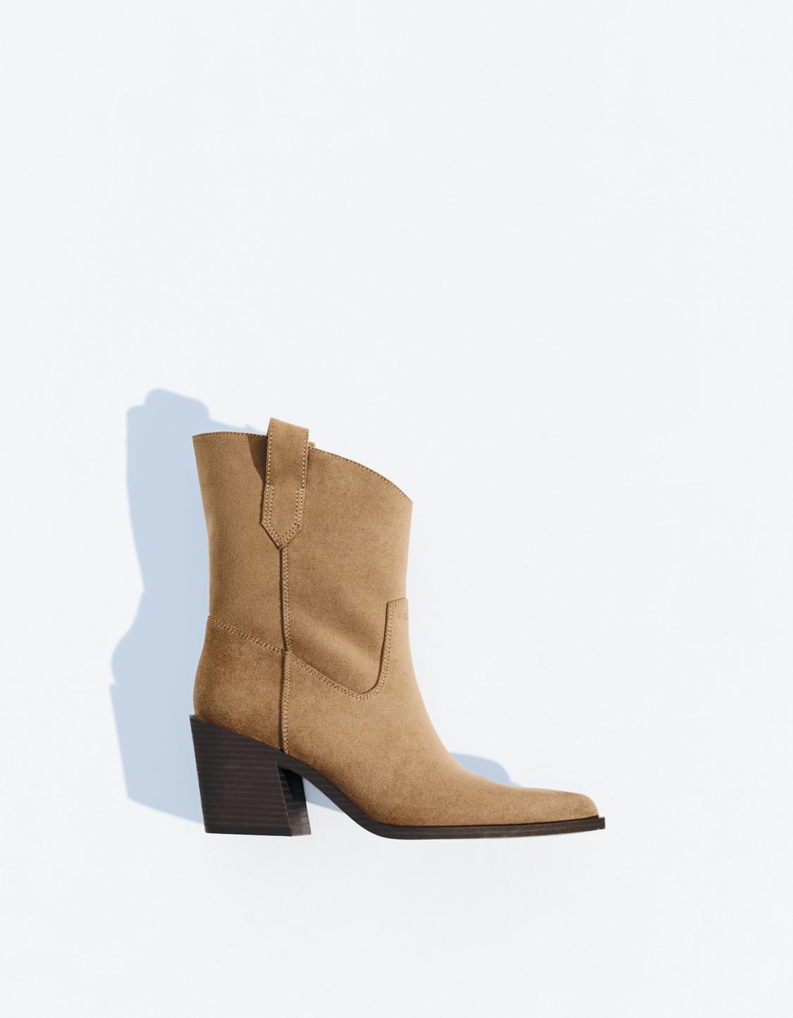 Asymmetric heeled cowboy ankle boots