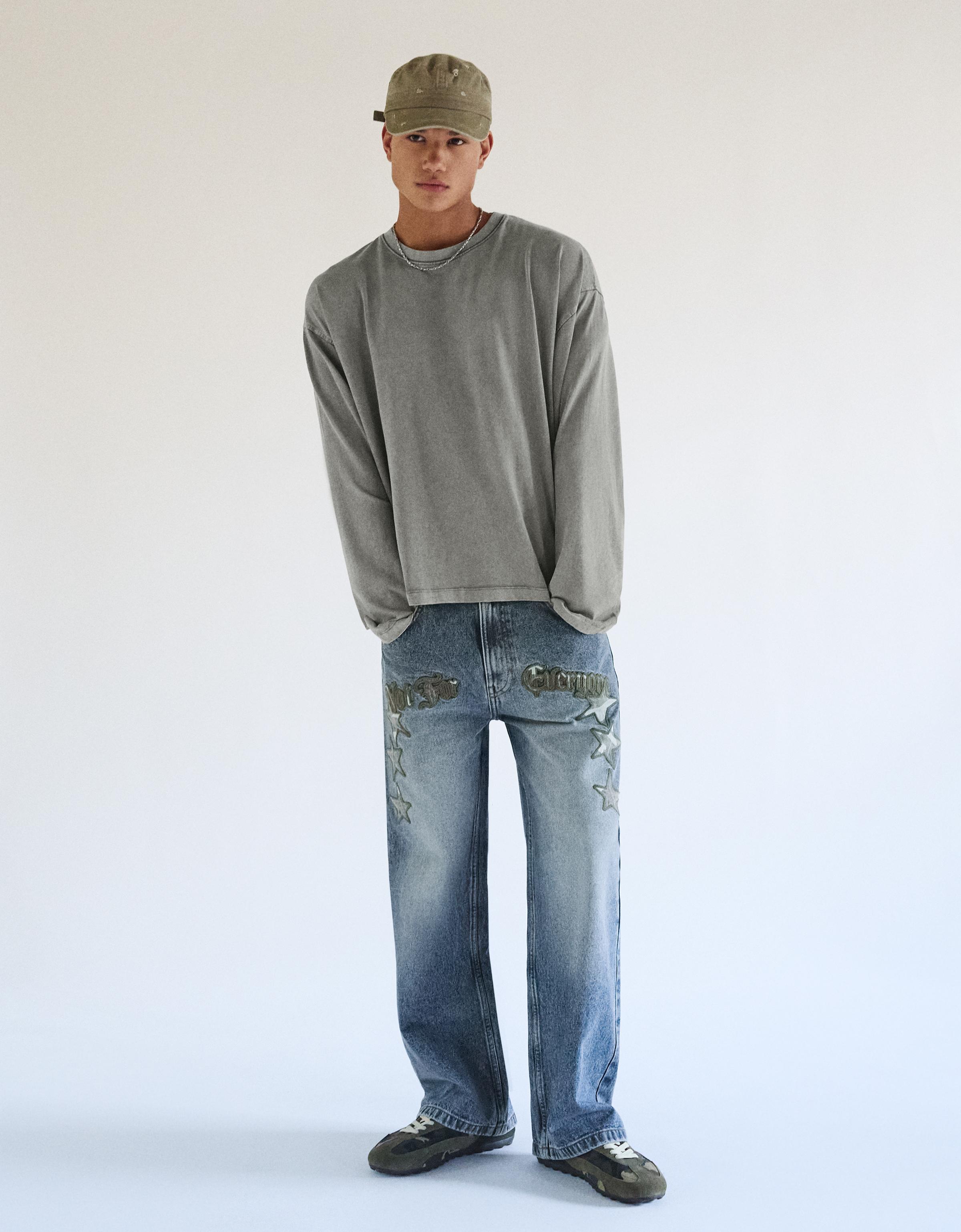 Bershka Jeansy O Kroju Super Baggy Z Naszywkami W Gwiazdy Mężczyzna 38 Wyblakły Niebieski