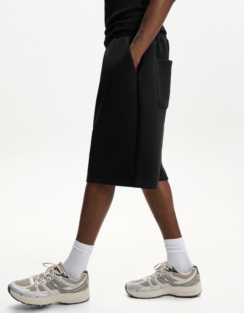 Oversize neoprene-effect Bermuda shorts-Black