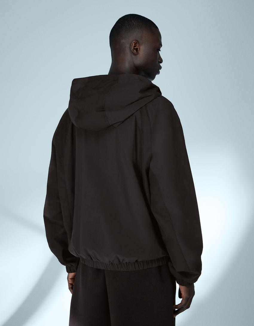 Cazadora técnica capucha-Negro