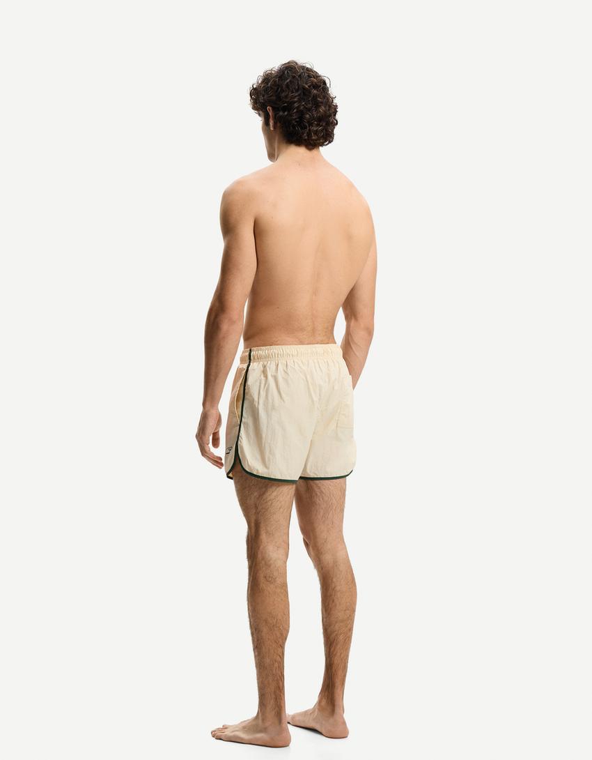 Kurze Badeshorts mit Borte-Sandfarbe