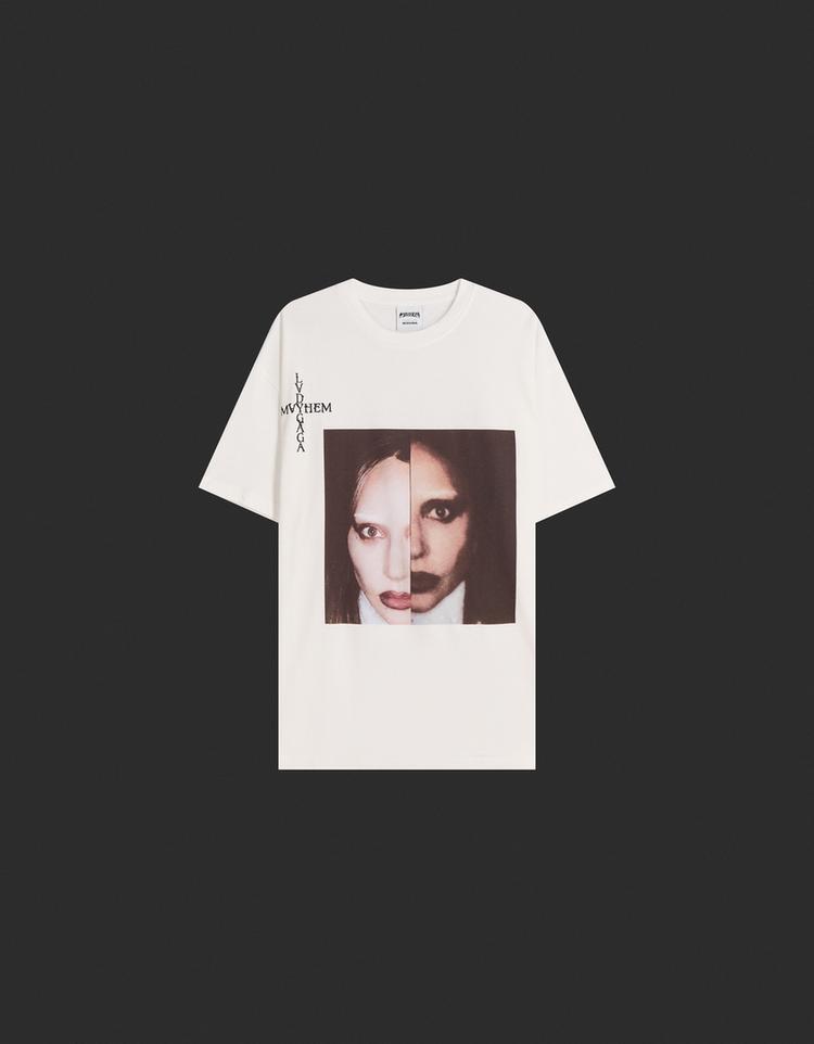 Front view of t-shirt with a print of two faces and the text "Lady Gaga" and "Mayhem" on the left side.
