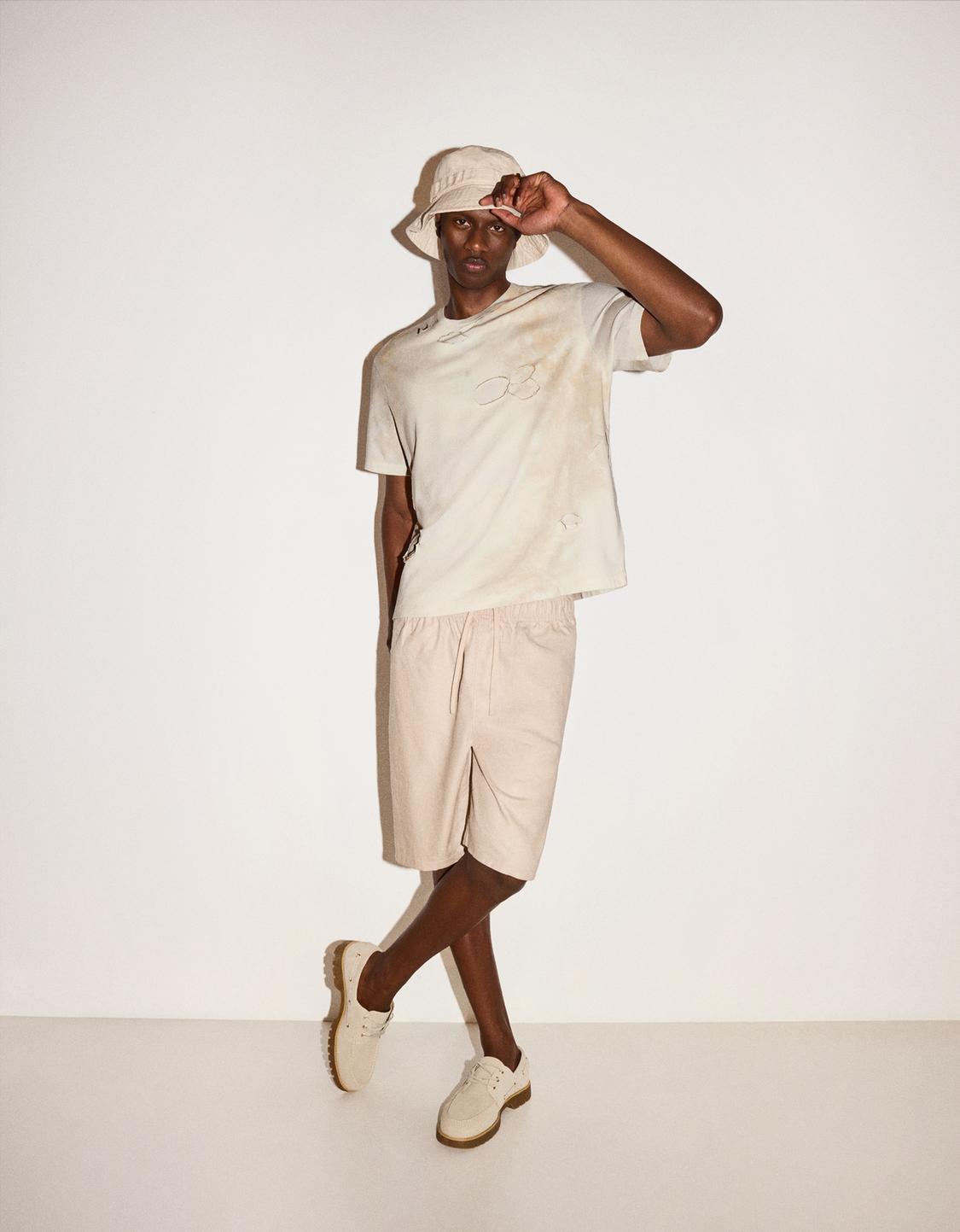 Faded-effect short sleeve ripped T-shirt