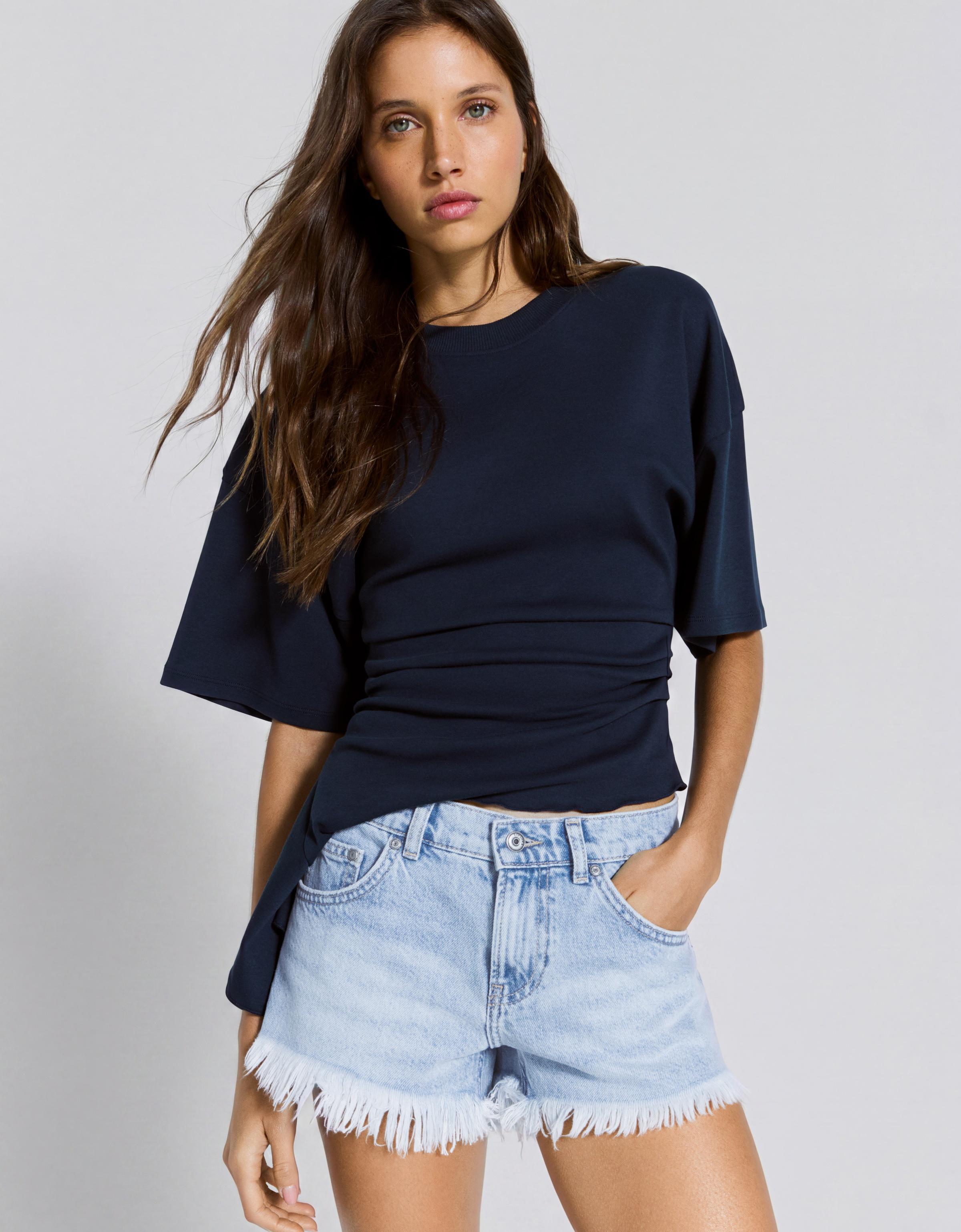 Denim mini shorts with frayed hem — Light blue