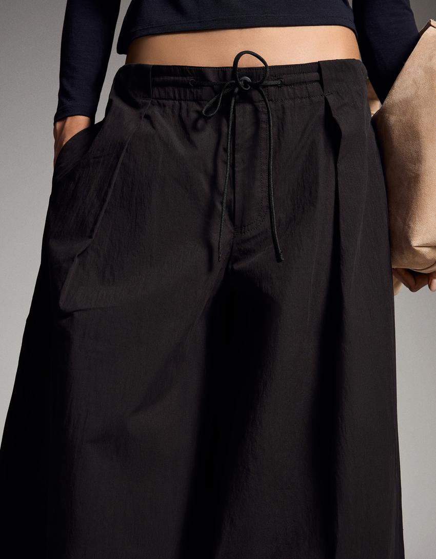 Pantaloni tecnici con pieghe-Nero