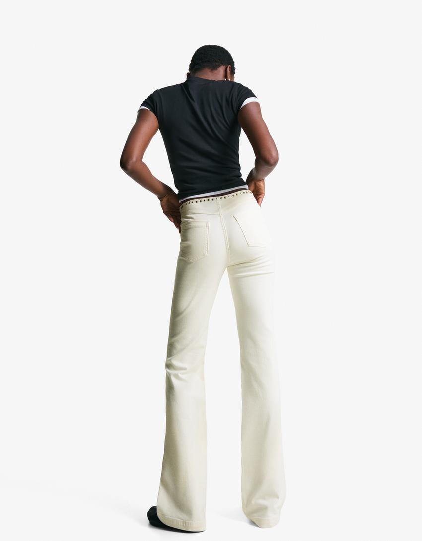 Pantaloni con borchie in vita e cerniera-Bianco Roto