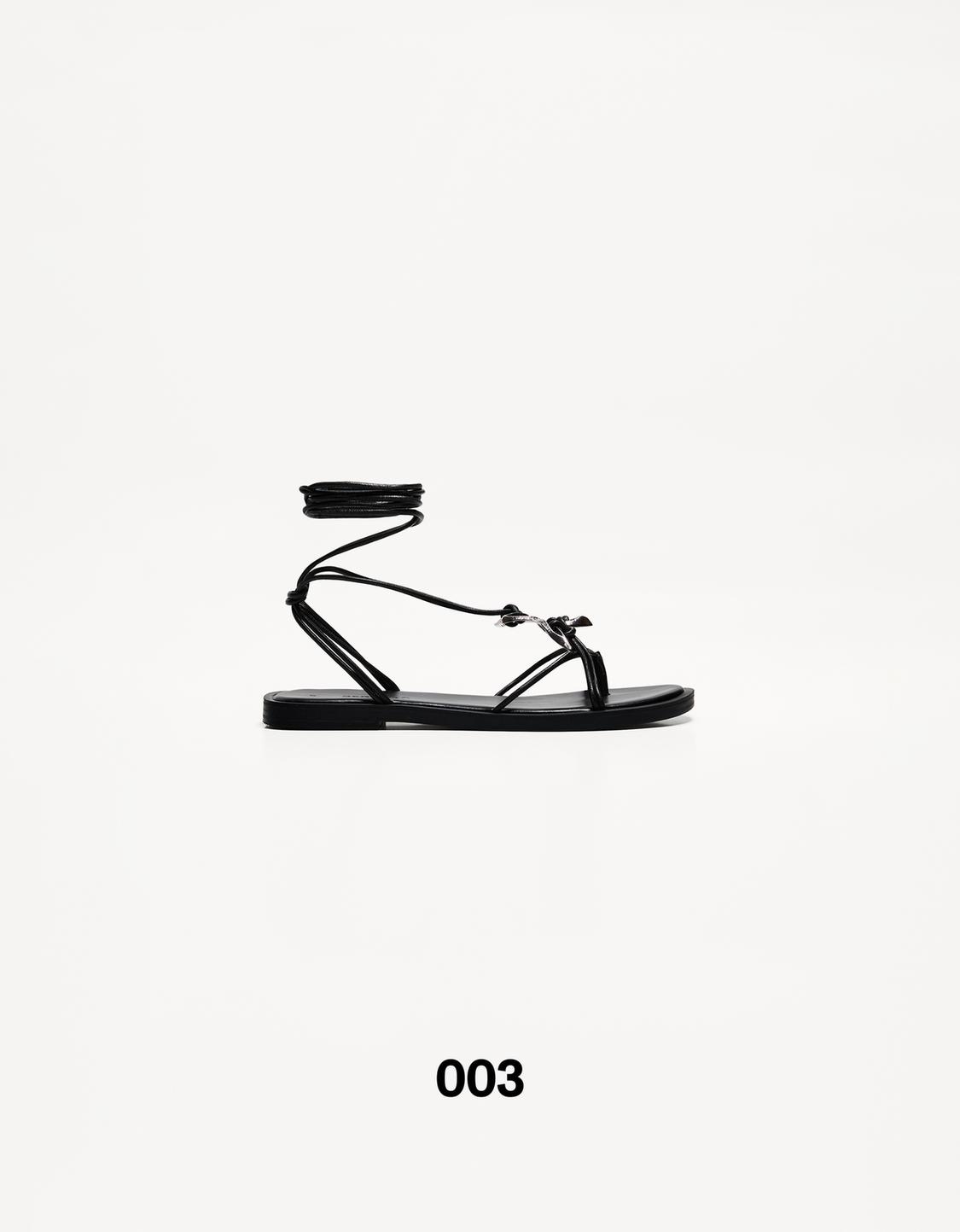 Flat lace-up sandals with metal detail
