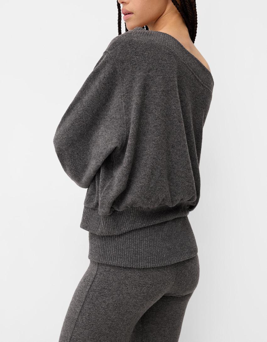 Flared trousers with fold-over waist