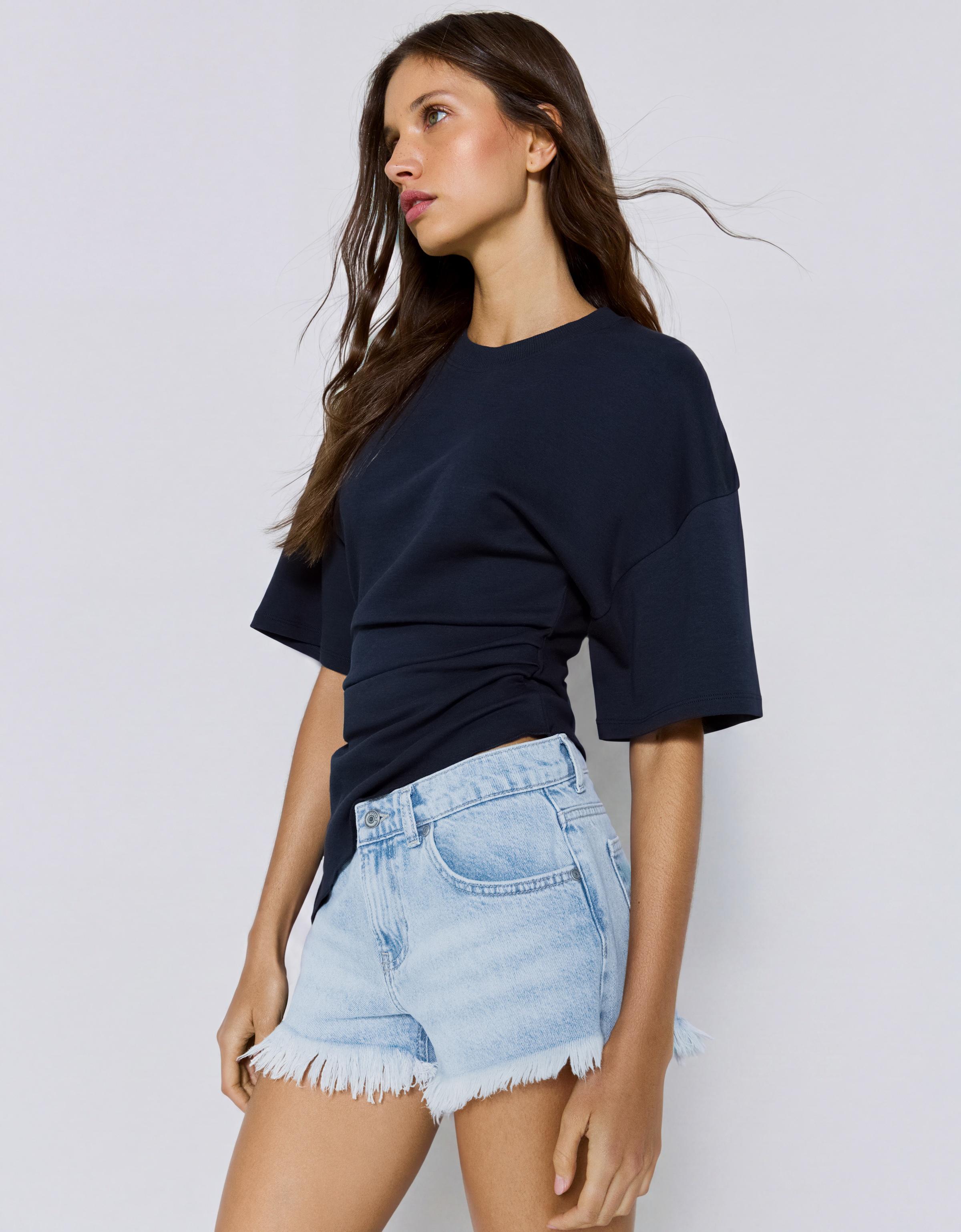 Denim mini shorts with frayed hem — Light blue