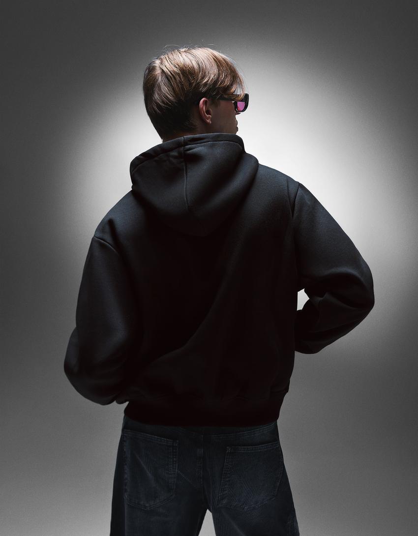 Dessuadora cremallera caputxa estampat-Negre