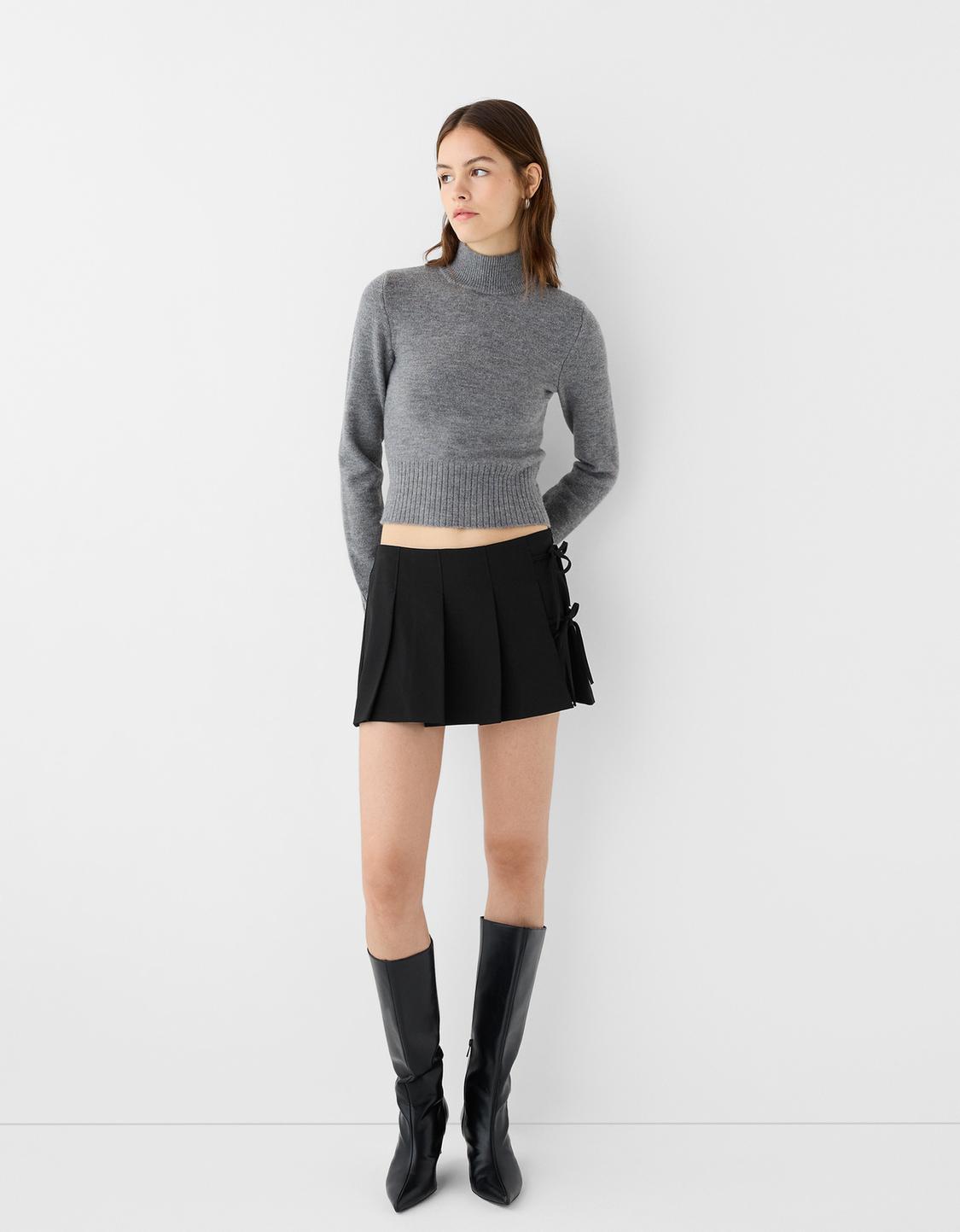 Box pleat mini skirt with bow detail